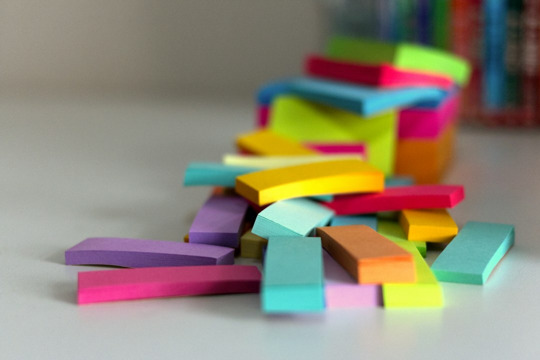 Close-up of colorful sticky notes and a notebook on a desk